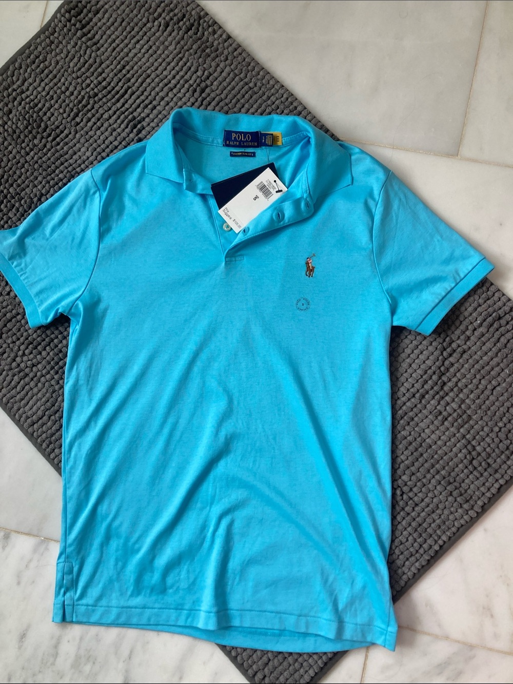 Polo by Ralph Lauren Men’s Polo Shirt - Blue in size small with tags attached